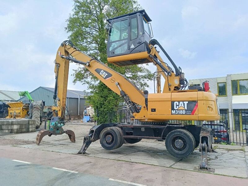 Cat M 318 MH overslagkraan waste handler umslagbagger - Manipulador de materiales: foto 1 Cat M 318 MH overslagkraan waste handler umslagbagger - Manipulador de materiales: foto 1