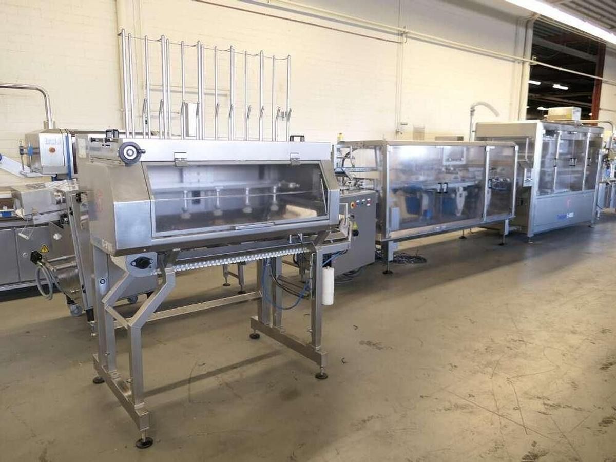 Tramper filling- and traysealing line - Máquina de embalaje: foto 1 Tramper filling- and traysealing line - Máquina de embalaje: foto 1