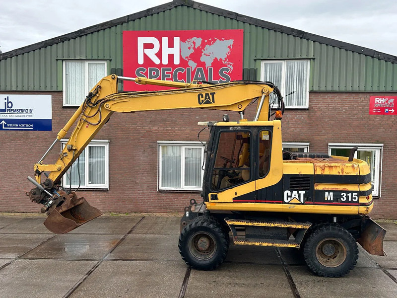 Caterpillar M315 +ROTO CE - Excavadora de ruedas: foto 1 Caterpillar M315 +ROTO CE - Excavadora de ruedas: foto 1